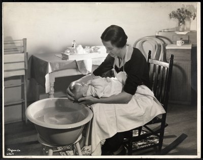 A woman washing a baby